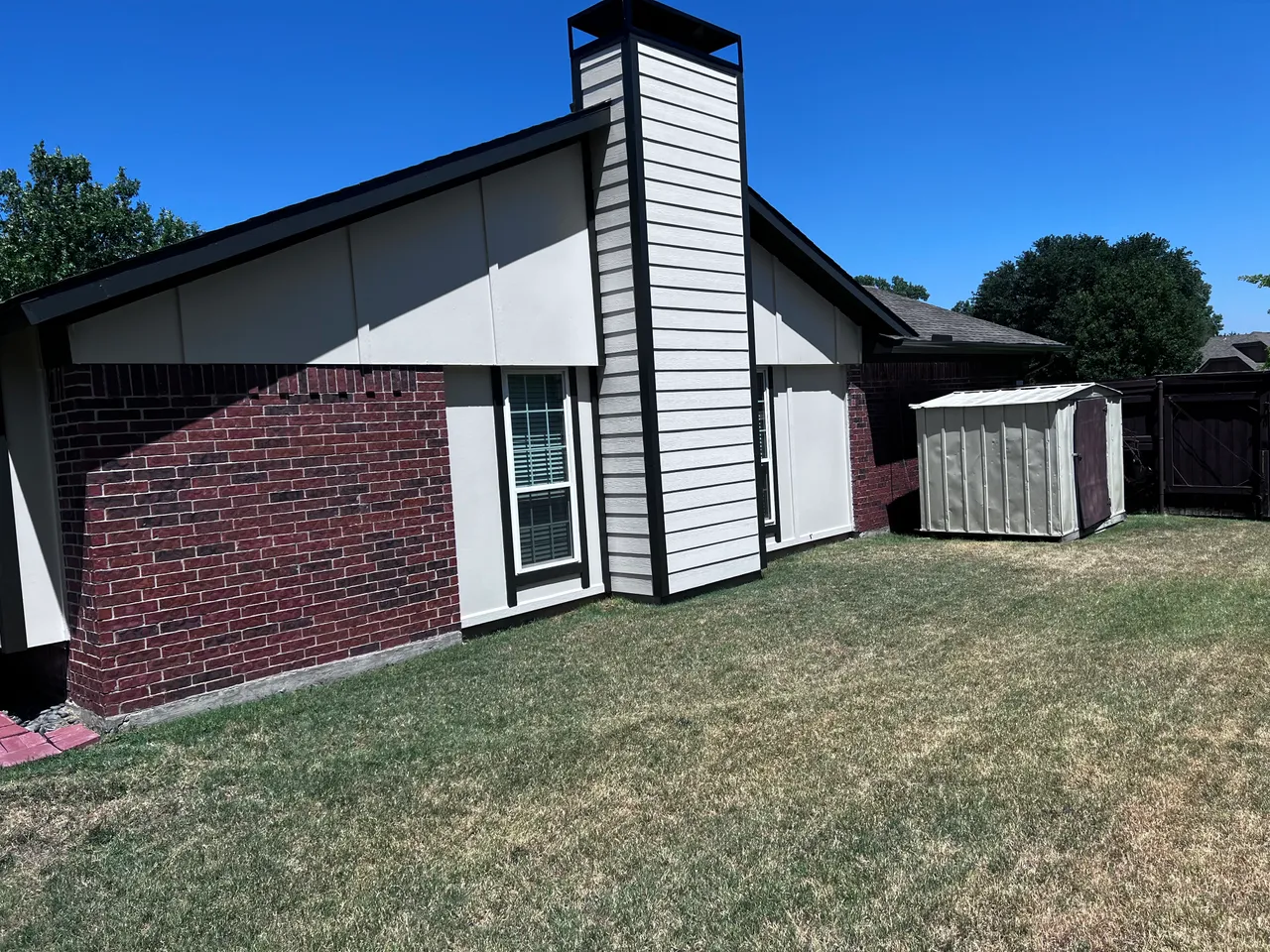 Chimney and gable siding replaced and painted white with black trim in Garland, TX